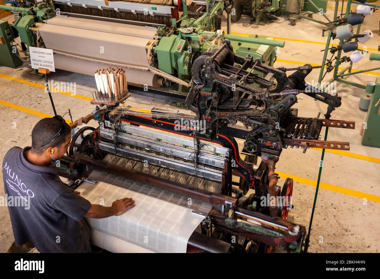 South Africa, Western Cape, Plettenberg Bay, Old Nick Village, Mungo Mill, weaver operating historic, Lancashire loom, weaving organic cotton baby bla Stock Photo