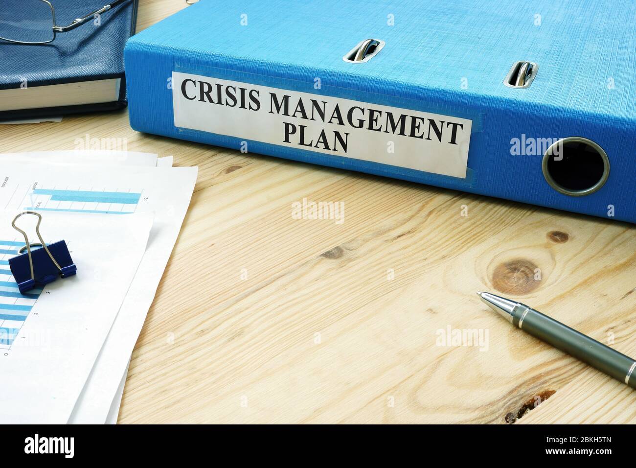 Big folder with label Crisis Management Plan and papers. Stock Photo