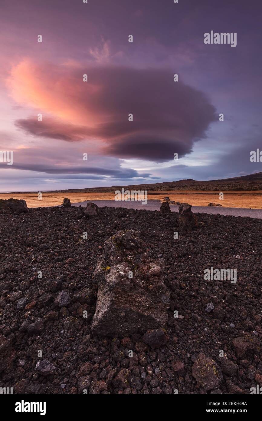 Strange cloud over icelandic volcanic rocks Stock Photo