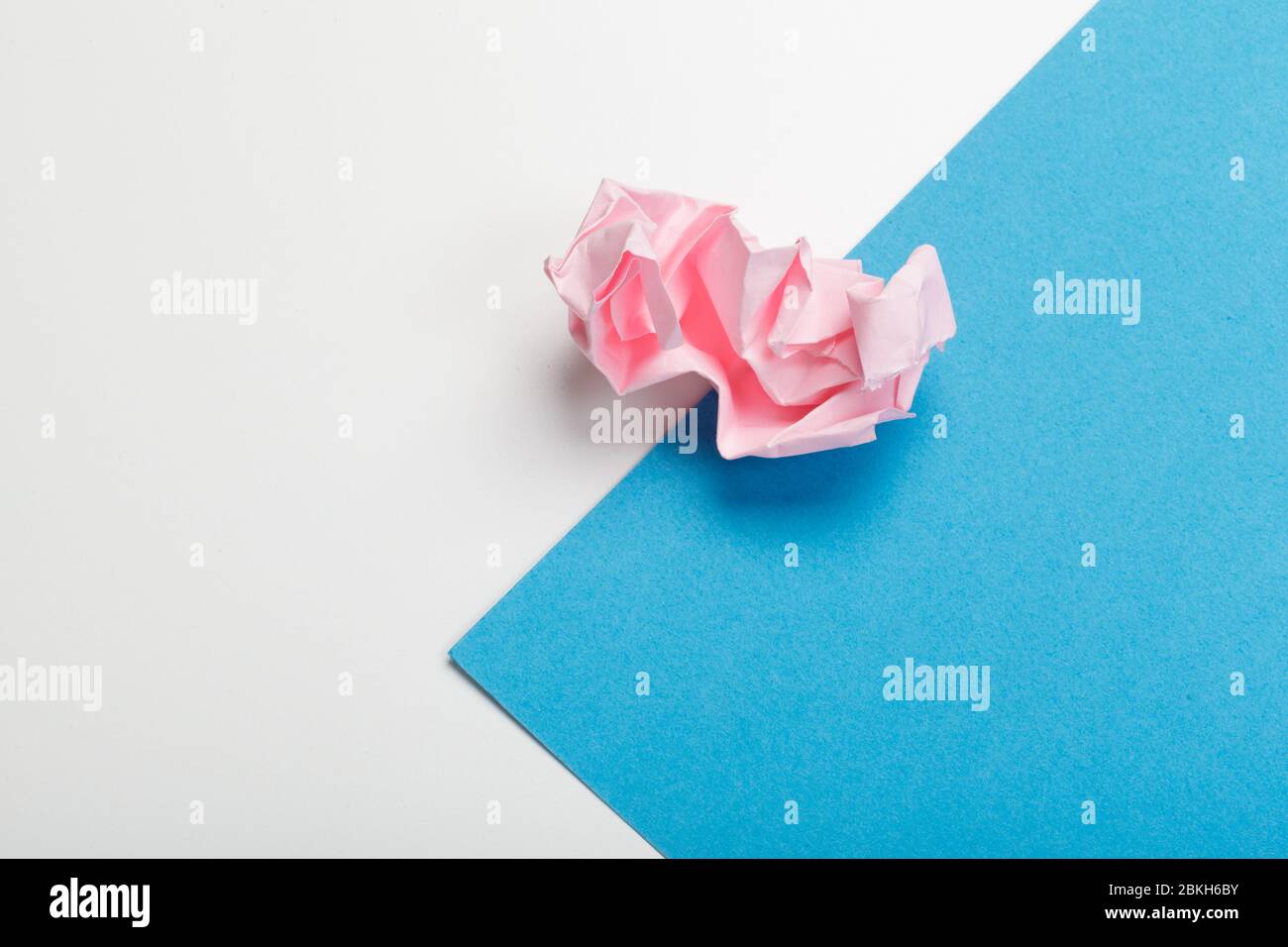 Wadded paper balls on a blue background Stock Photo