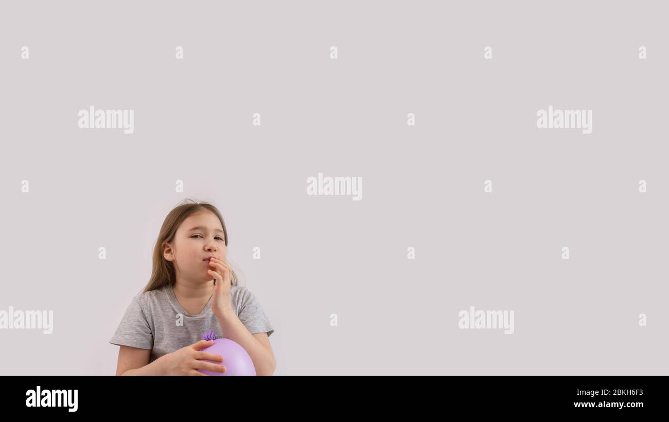 Young sad girl play with protective medical glove. Teenager with glove inflated like balloon. Quarantine, self isolation, depression, social distance, Stock Photo