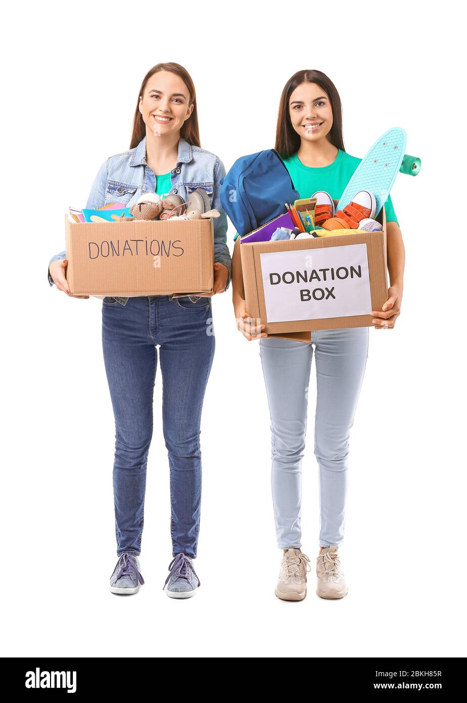 Volunteers with donations for orphans on white background Stock Photo