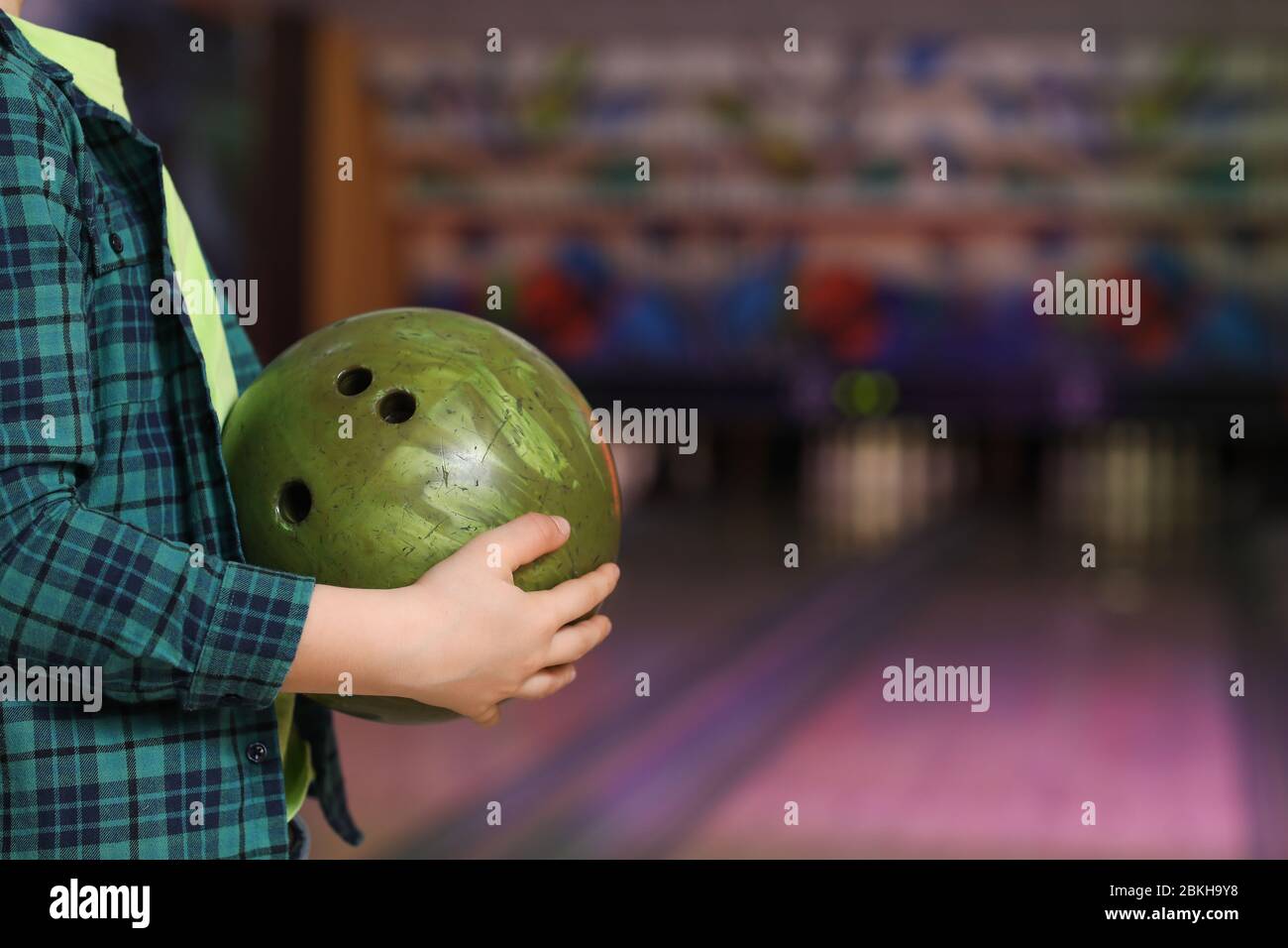 Little boy playing bowling in club Stock Photo - Alamy