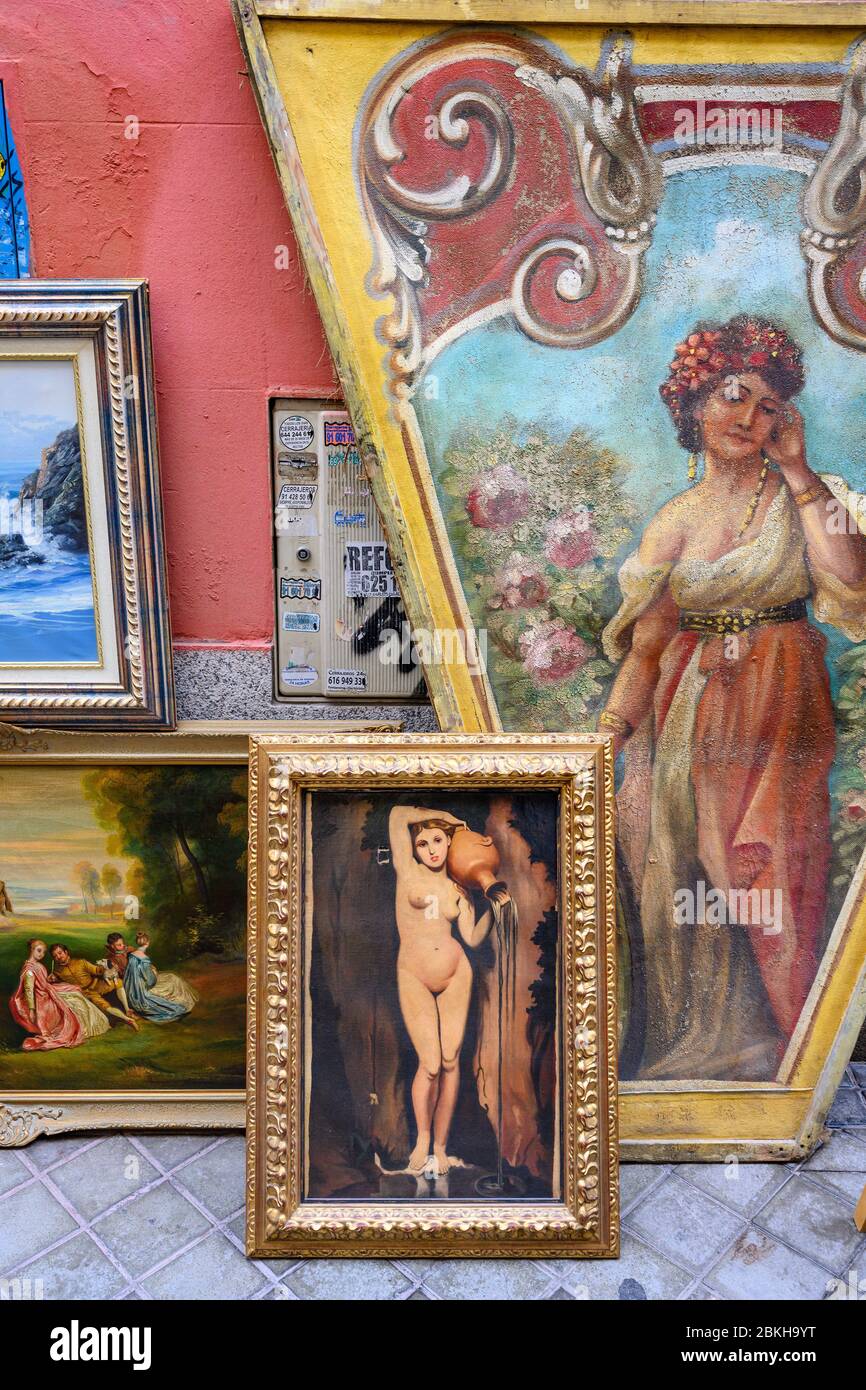 Paintings on sale in the Rastro flea market around the Plaza de Cascorro between La Latina and Embajadores,  Madrid, Spain. Stock Photo