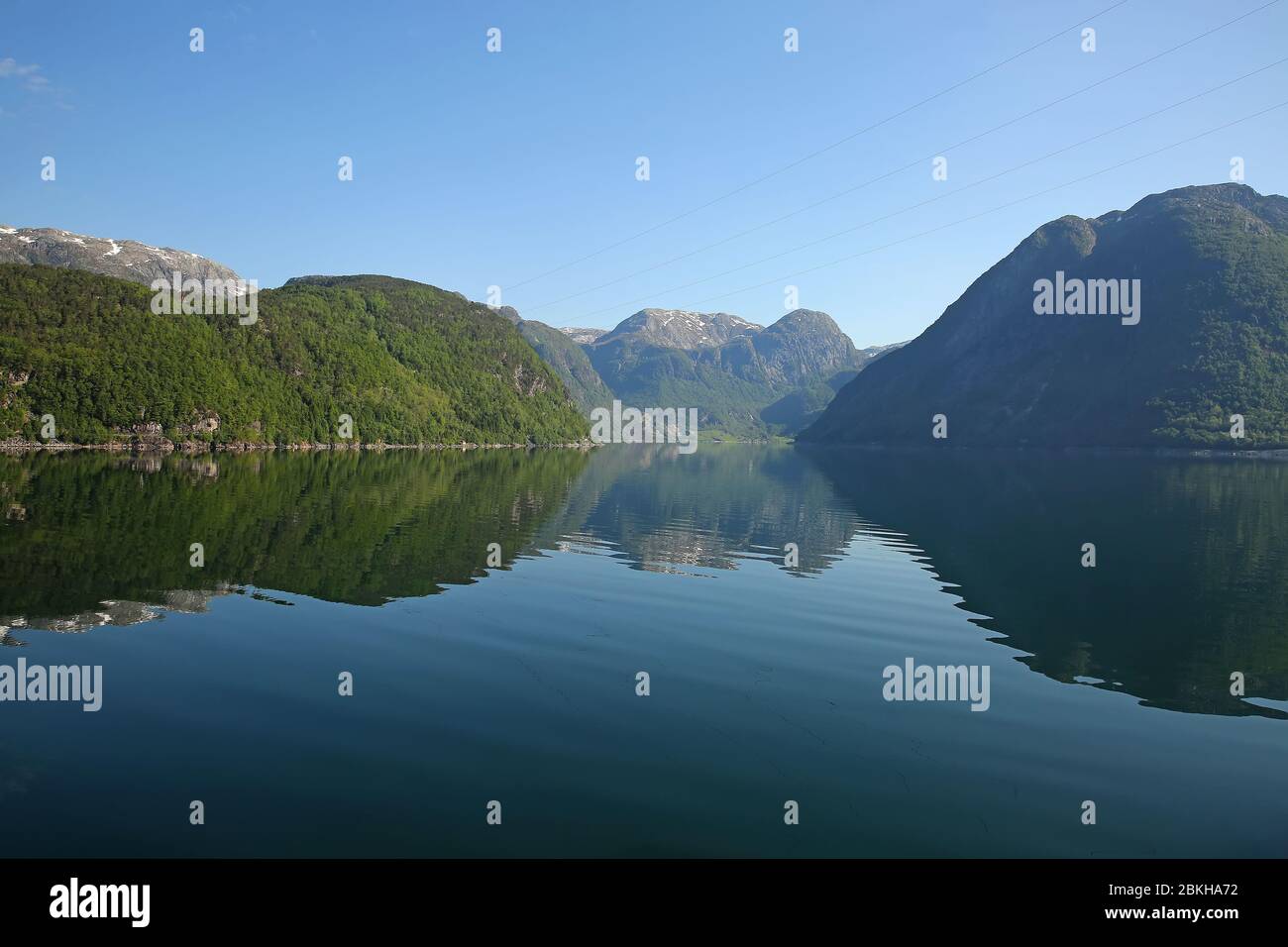 Beautiful landscape in the fjord, with reflections of the mountains in the water. Peace & tranquility, Rosendal, Hardangerfjord, Norway. Stock Photo