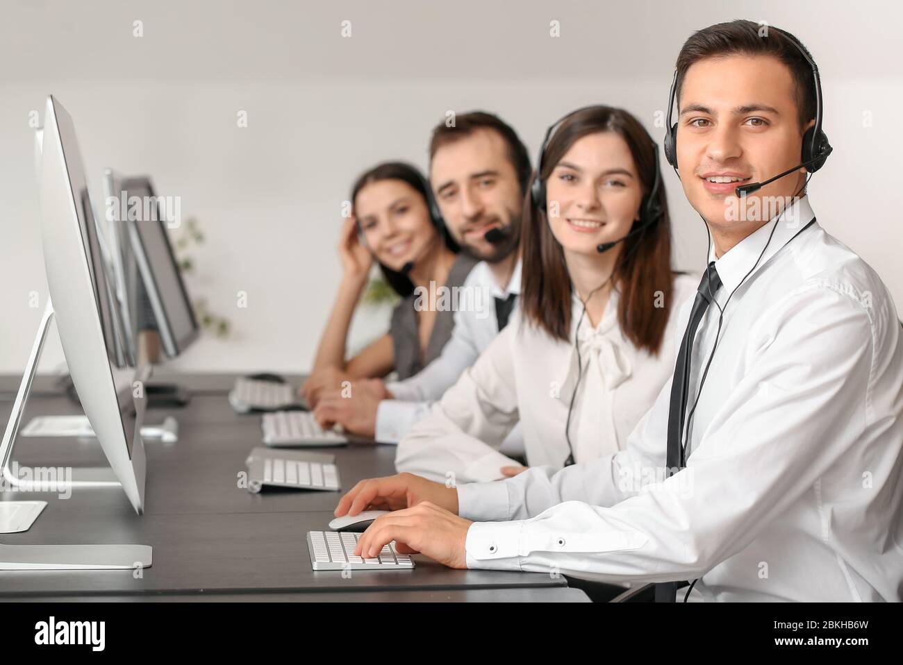 Team of technical support agents working in office Stock Photo - Alamy