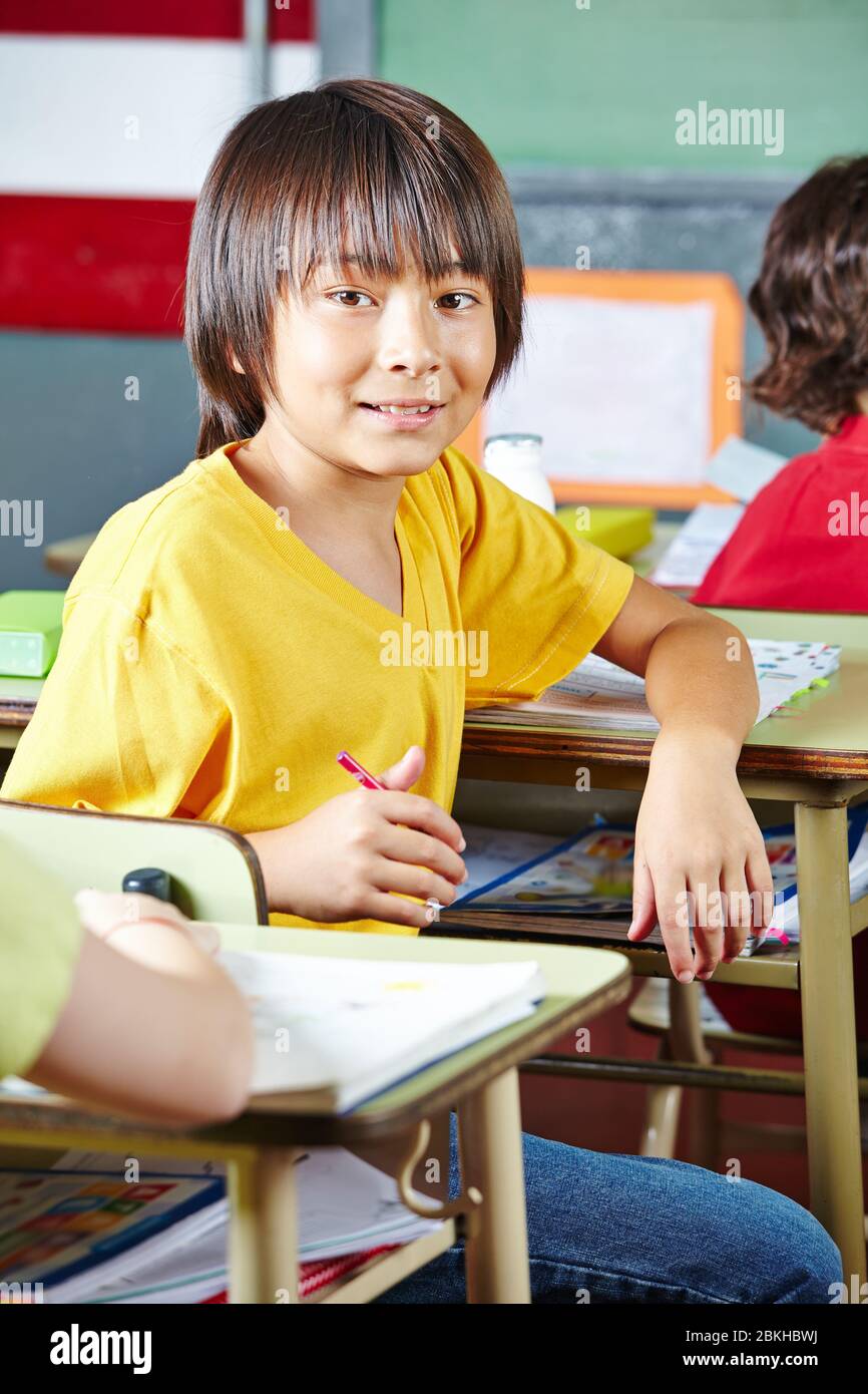 Japanese child smiles contentedly in class at school Stock Photo