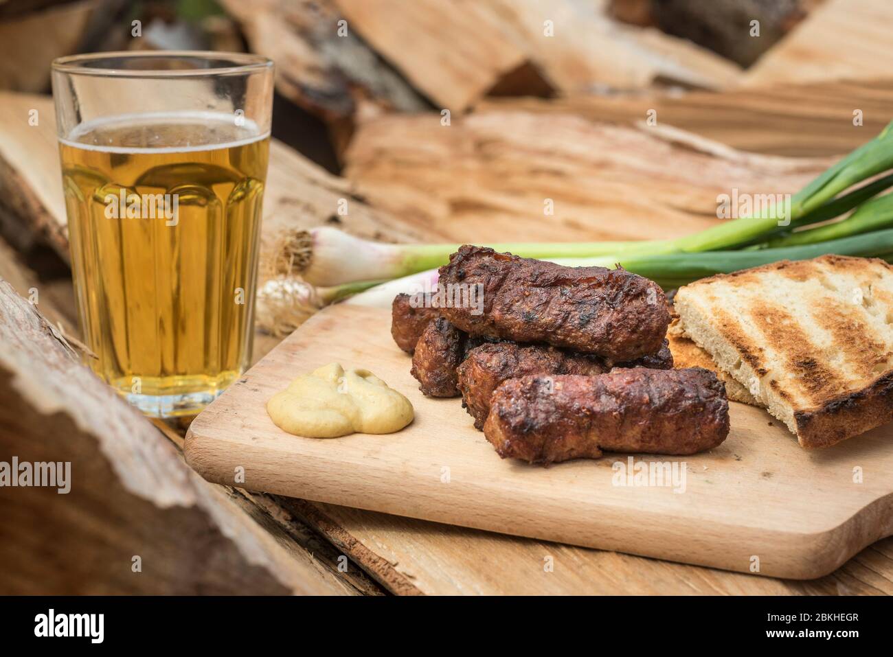 Mici cu bere traditional Romanian dish for celebrations the 1st of May the  labor day. Meet balls meat rolls dish and beer Turkish kofte Stock Photo -  Alamy