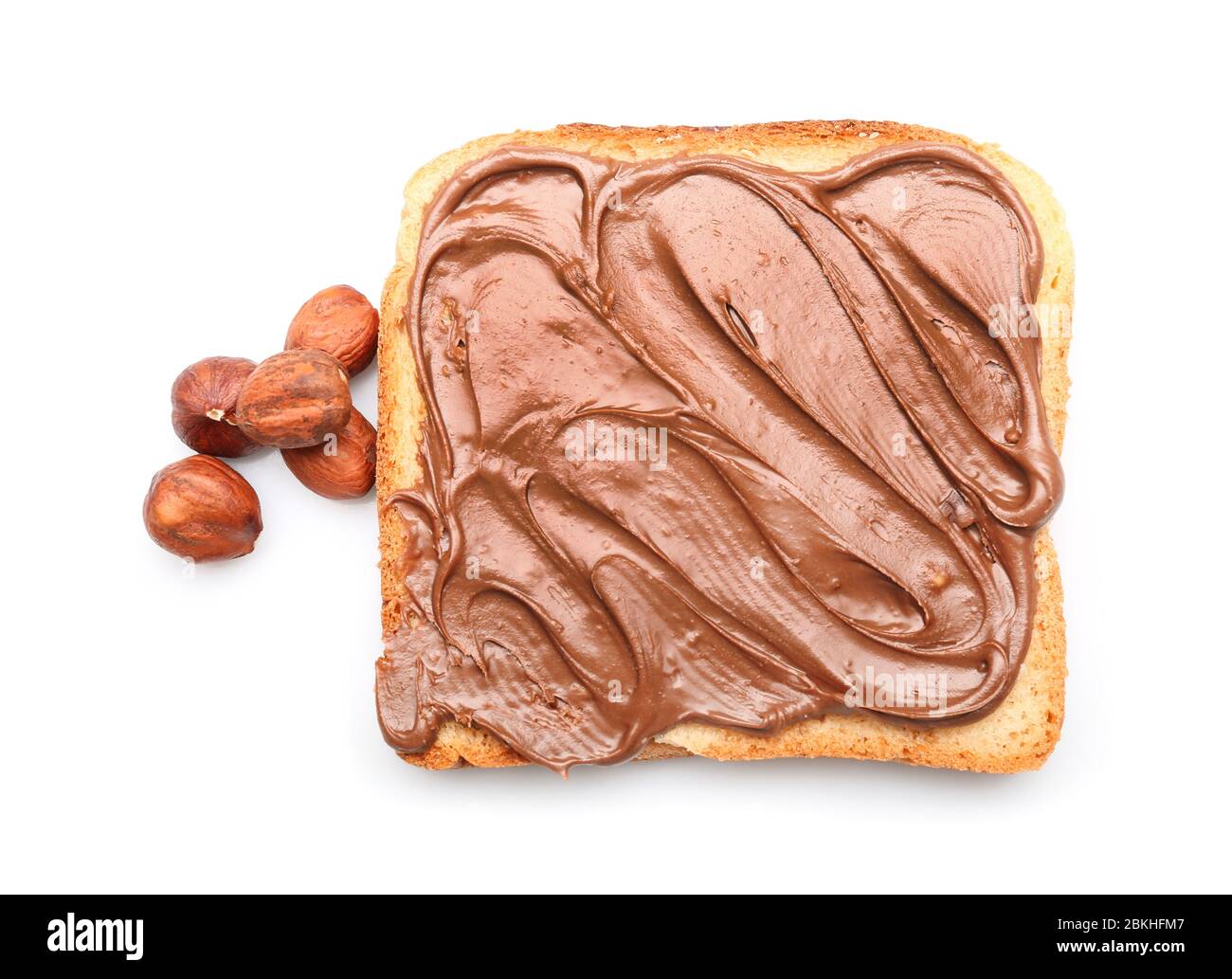 Fresh bread with tasty chocolate paste and hazelnuts on white ...