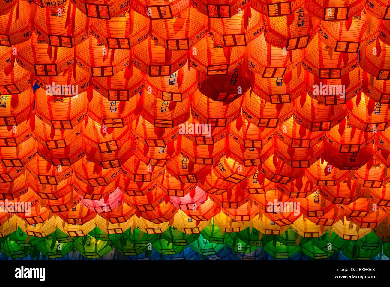 Rows and rows of colorful illuminated buddhist lotus lanterns hanging overhead at the . Jogyesa Buddhist temple in Seoul, South Korea. Stock Photo
