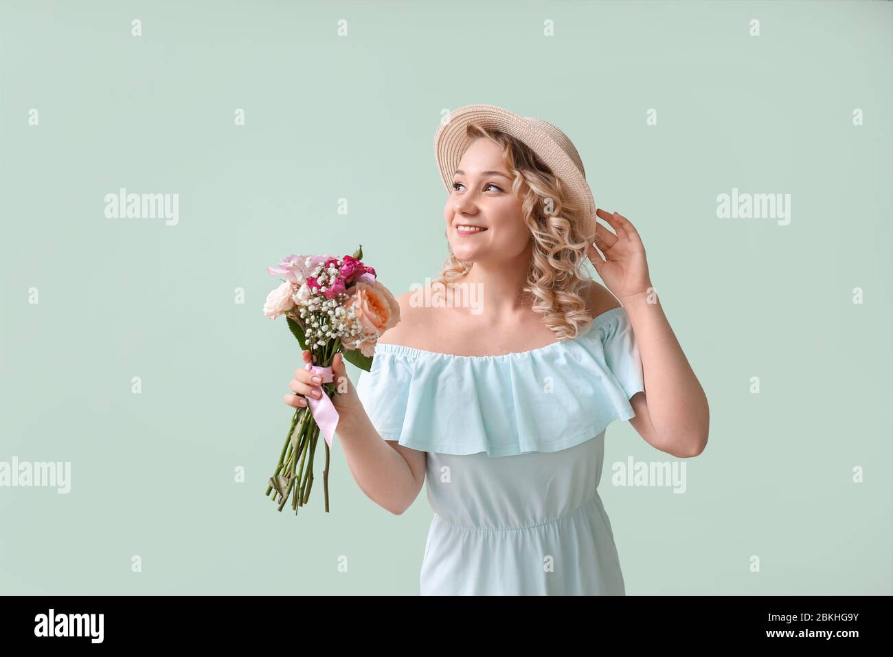 Beautiful young woman with bouquet of flowers on color background Stock ...