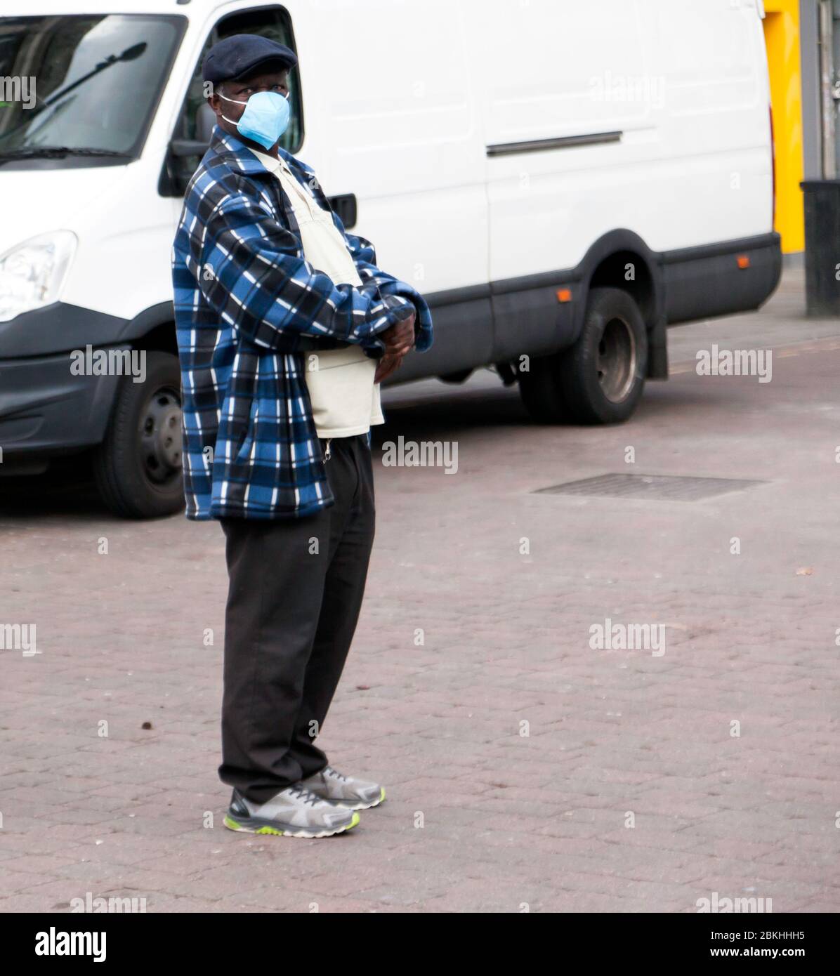 Man, near Lewisham Market, wearing a face mask to help protect him and others, from spreading COVID-19, during the Lockdown Period Stock Photo