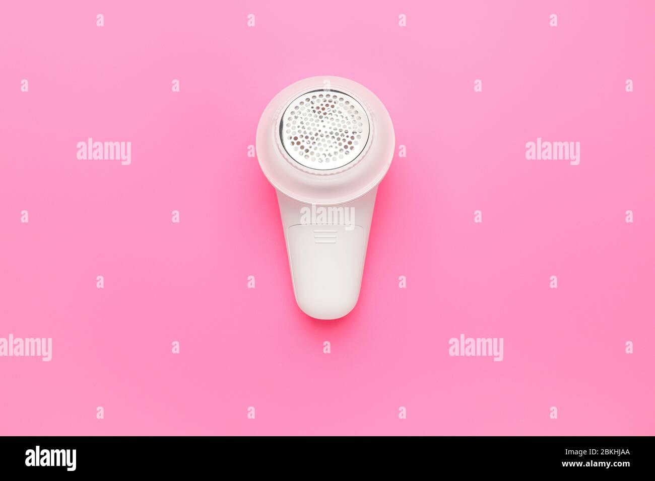 Modern fabric shaver on color background Stock Photo