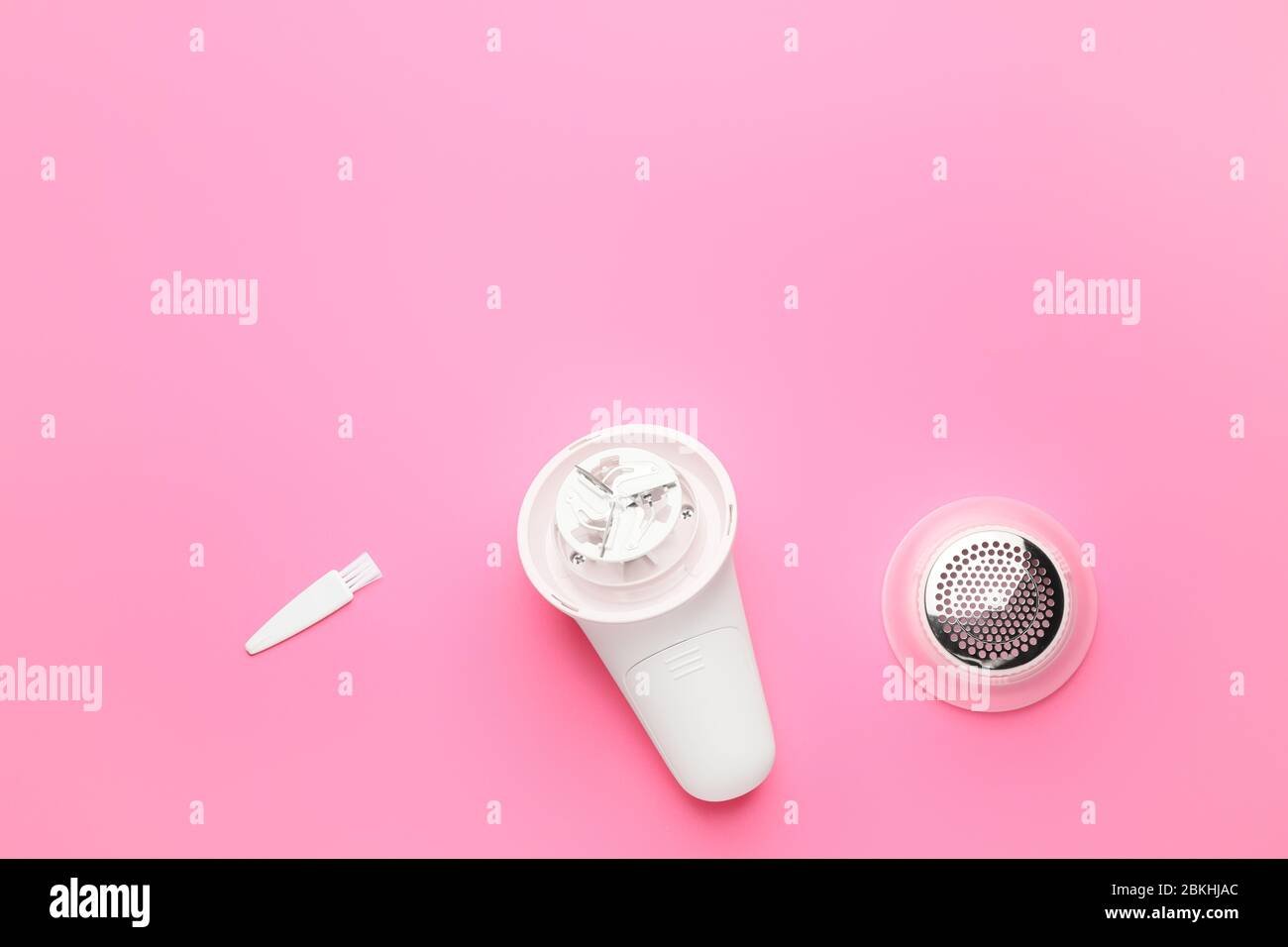 Modern fabric shaver on color background Stock Photo