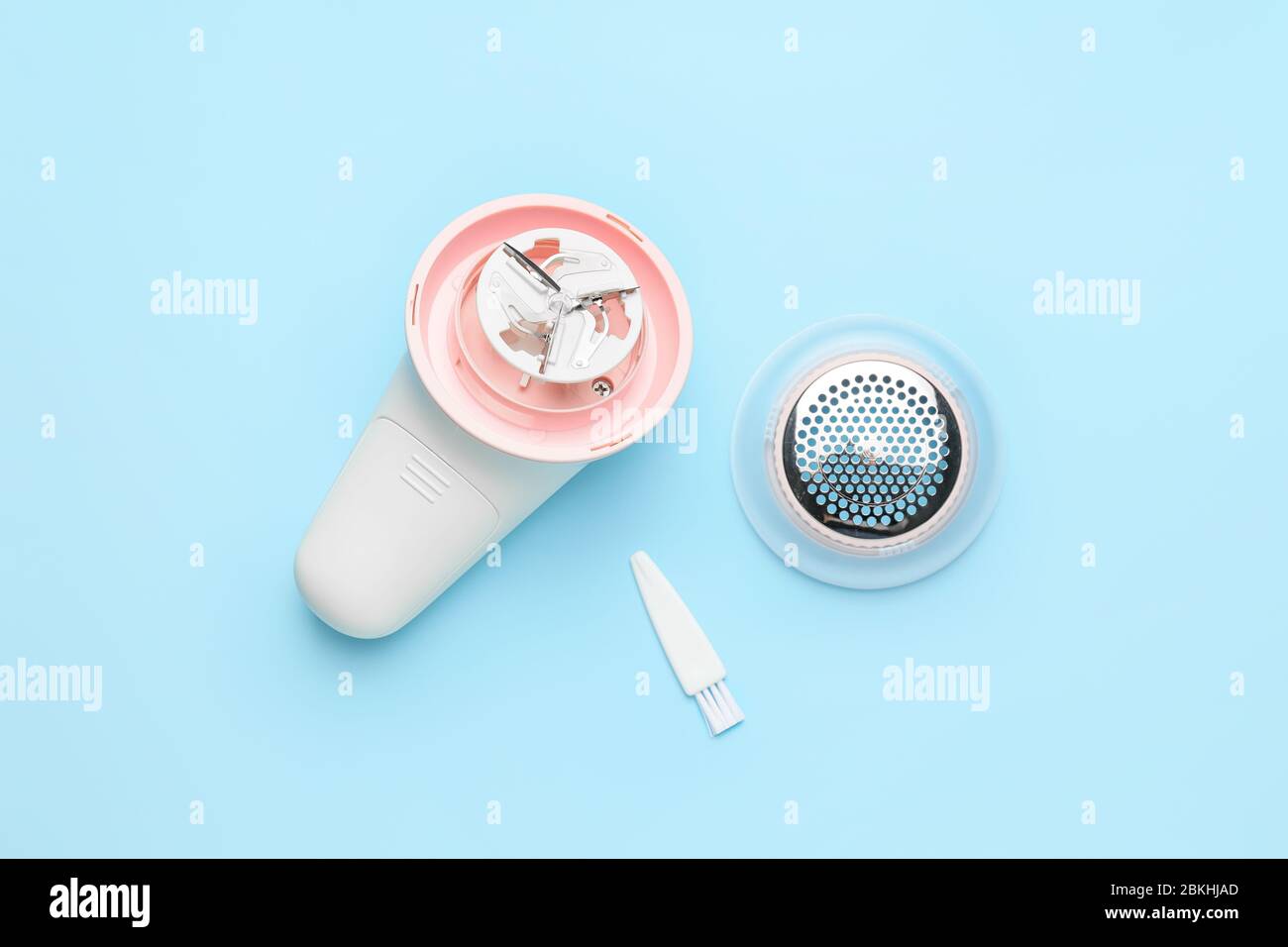 Modern fabric shaver on color background Stock Photo
