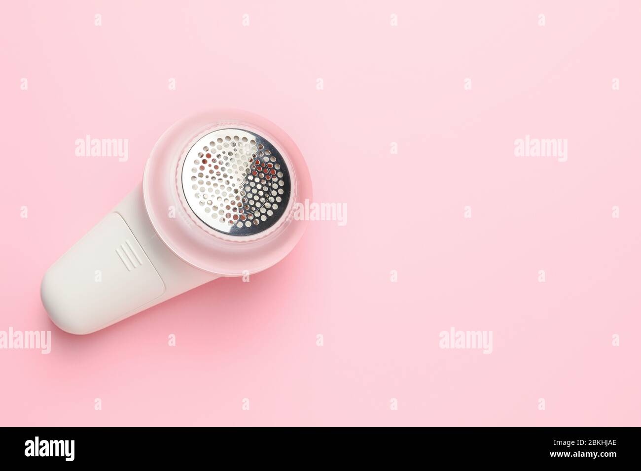 Modern fabric shaver on color background Stock Photo