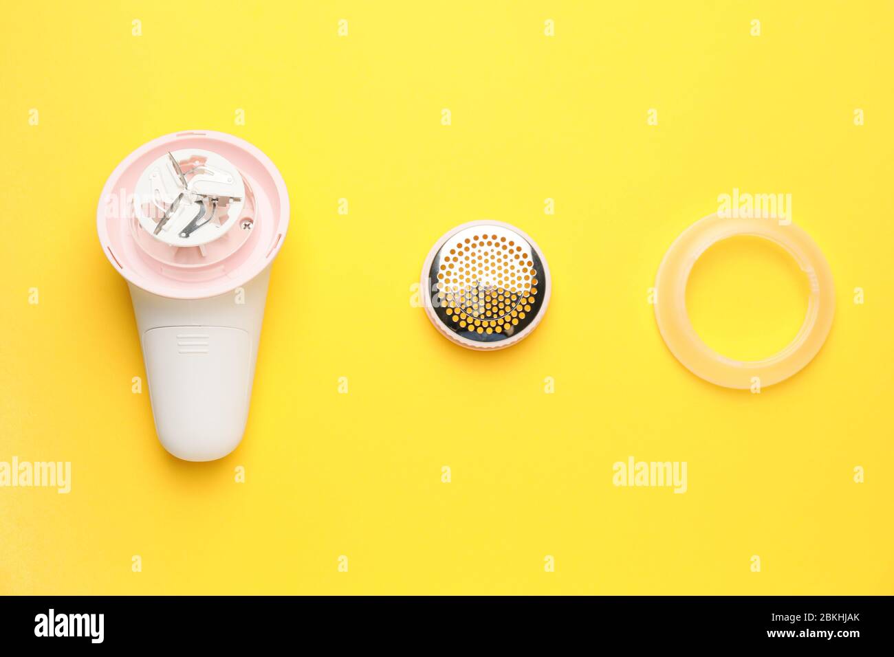 Modern fabric shaver on color background Stock Photo