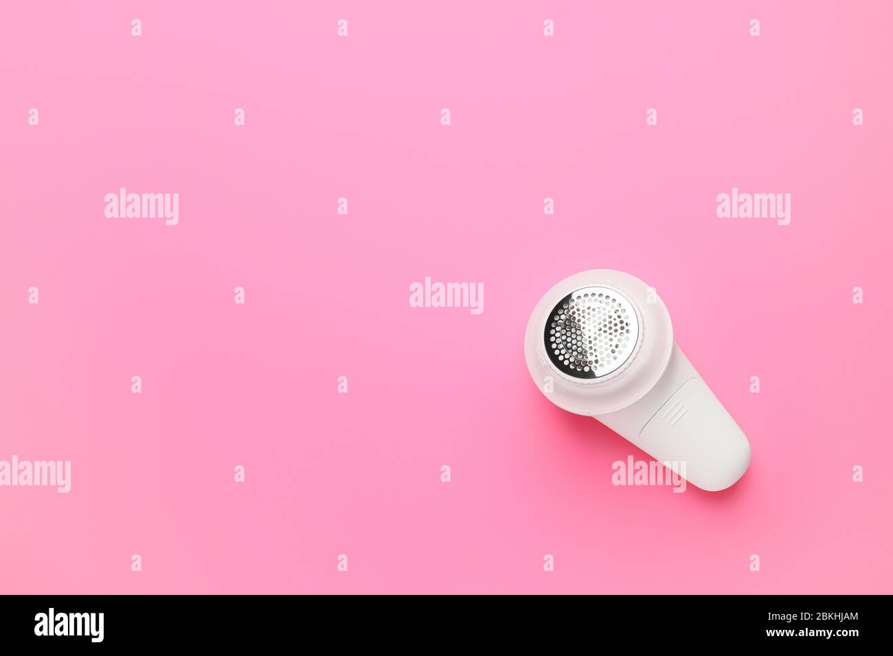 Modern fabric shaver on color background Stock Photo