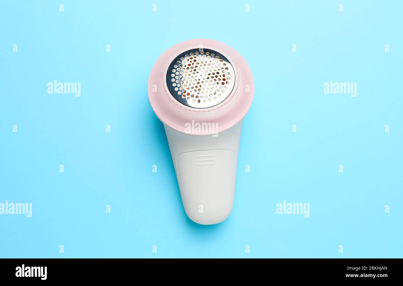 Modern fabric shaver on color background Stock Photo
