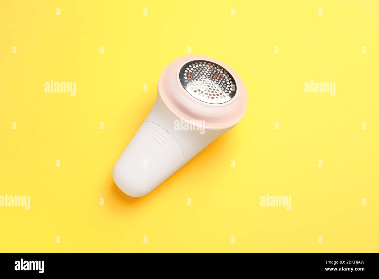 Modern fabric shaver on color background Stock Photo