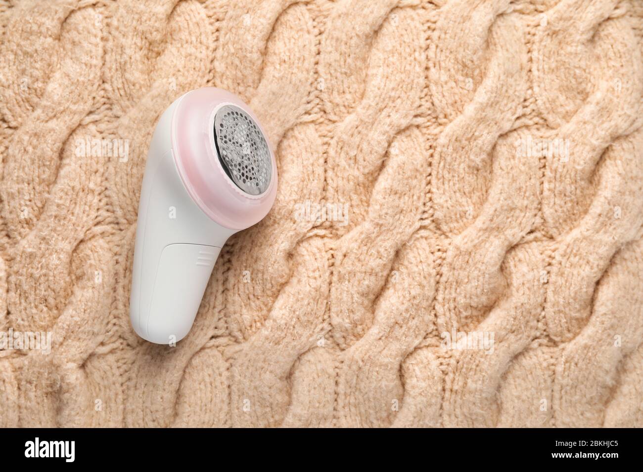 Modern fabric shaver on knitted clothes Stock Photo - Alamy