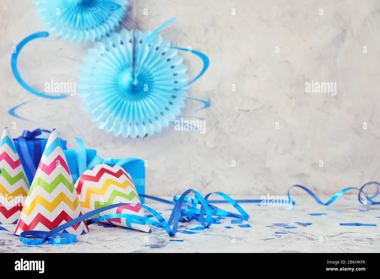 Party hats and decor on light background Stock Photo - Alamy