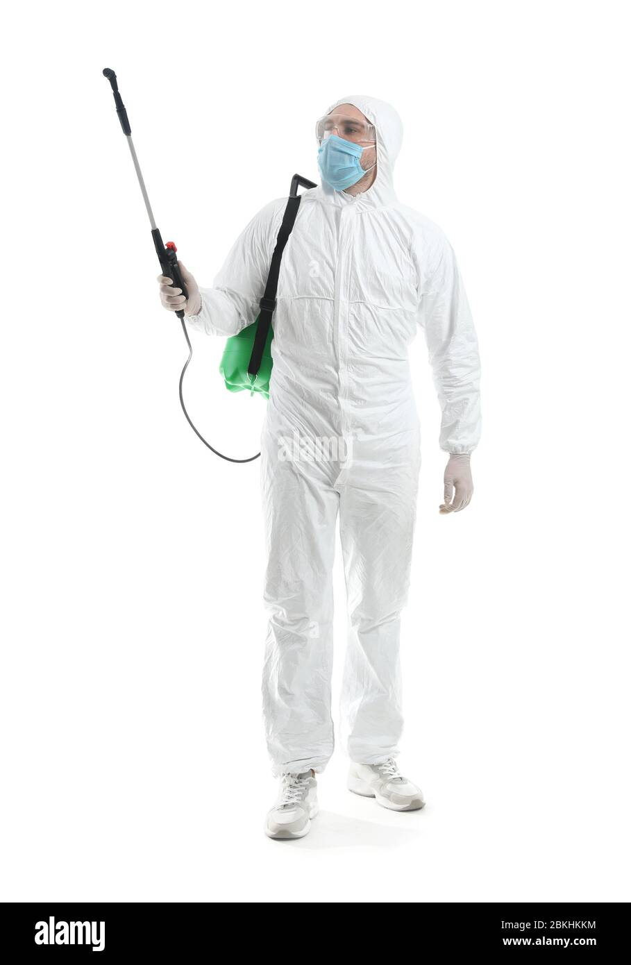 Worker in biohazard suit and with disinfectant on white background Stock Photo