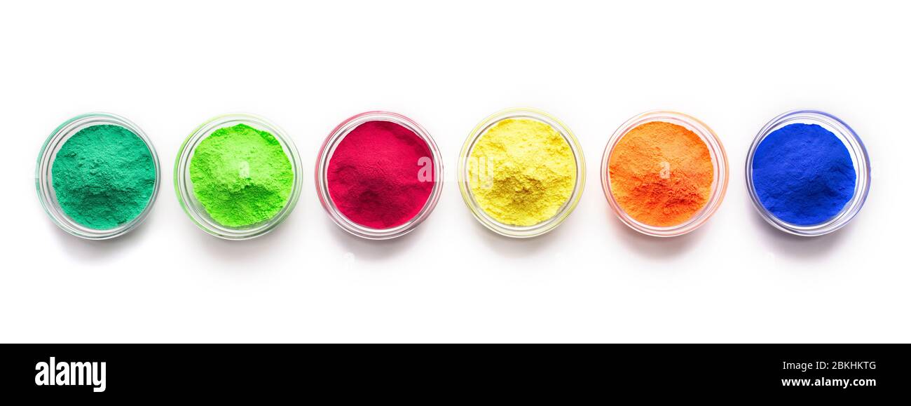Bright red, blue, green and yellow food powder on white background Stock Photo