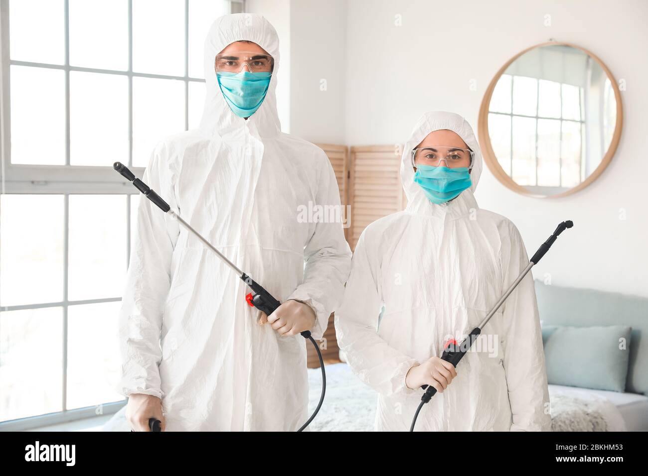 Workers in biohazard suits disinfecting house Stock Photo - Alamy