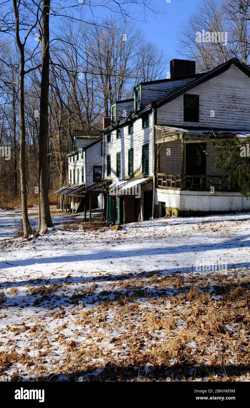 Abandoned houses in the deserted village of Feltville with snow covered ground in winter season.Berkeley Heights.New Jersey.USA Stock Photo