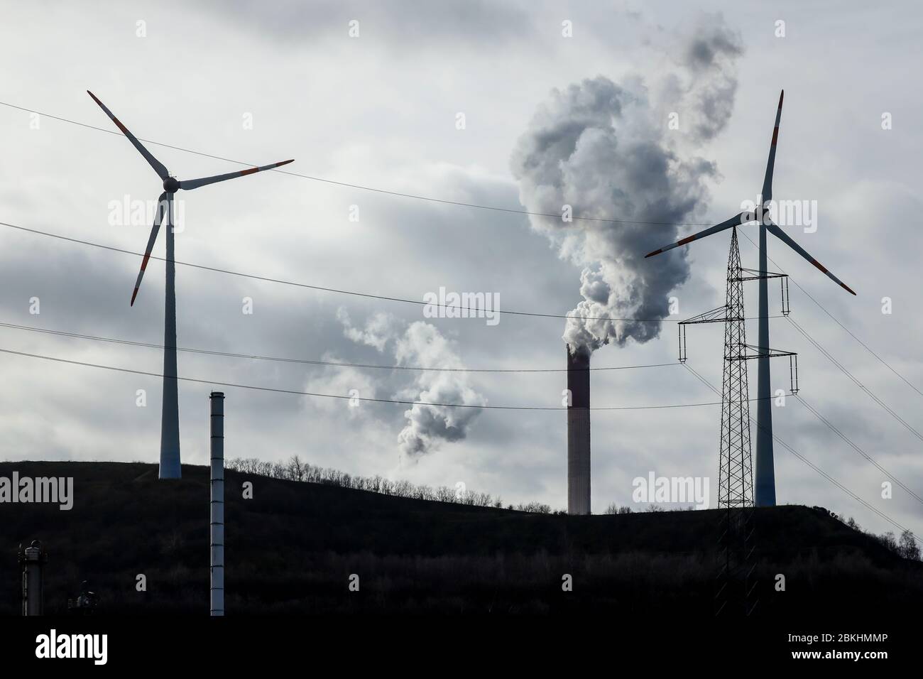 Gelsenkirchen, Ruhr Area, North Rhine-Westphalia, Germany - energy landscape, wind turbines, power pole and smoking chimneys at the Scholven power pla Stock Photo