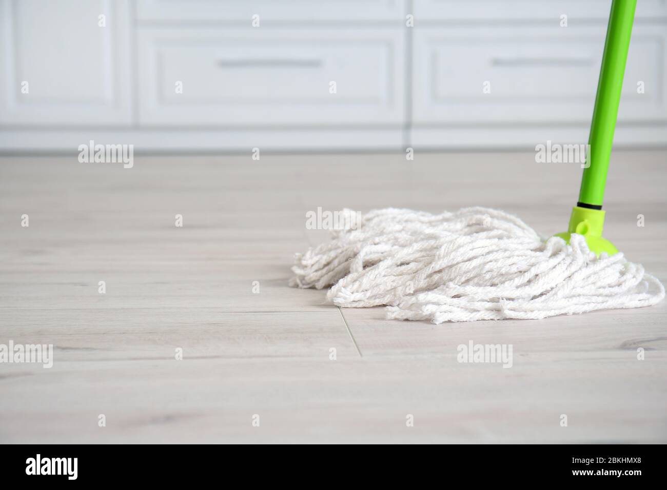 Mopping of floor in kitchen Stock Photo