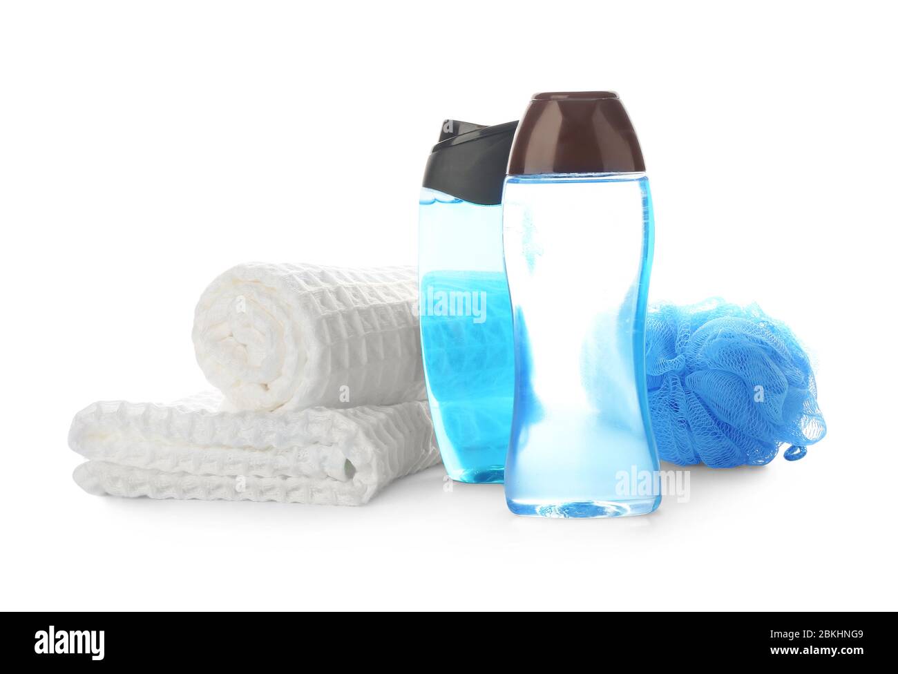 Shower gels, towel and loofah on white background Stock Photo