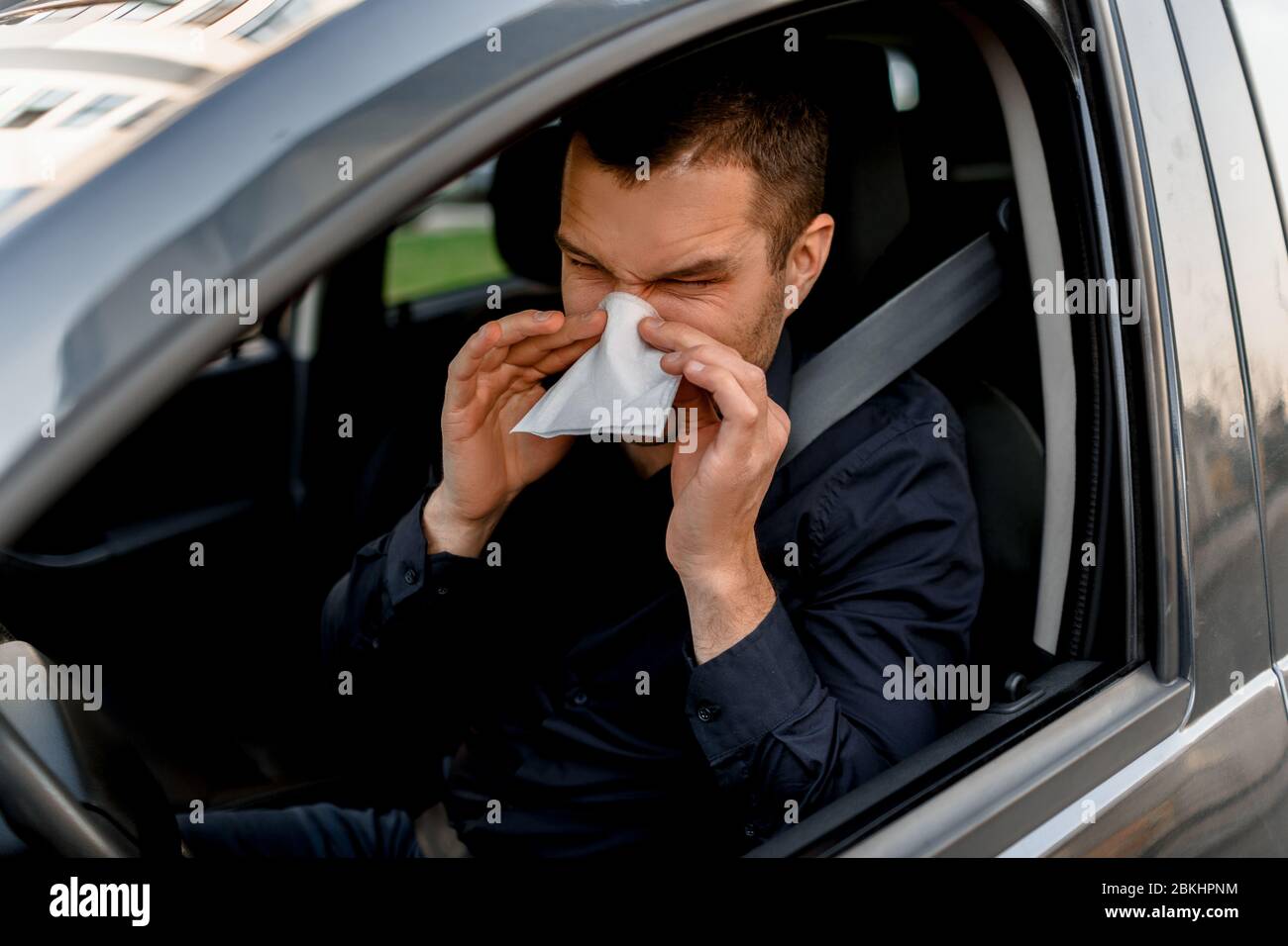 young man with handkerchief. Sick guy has runny nose. Male model makes