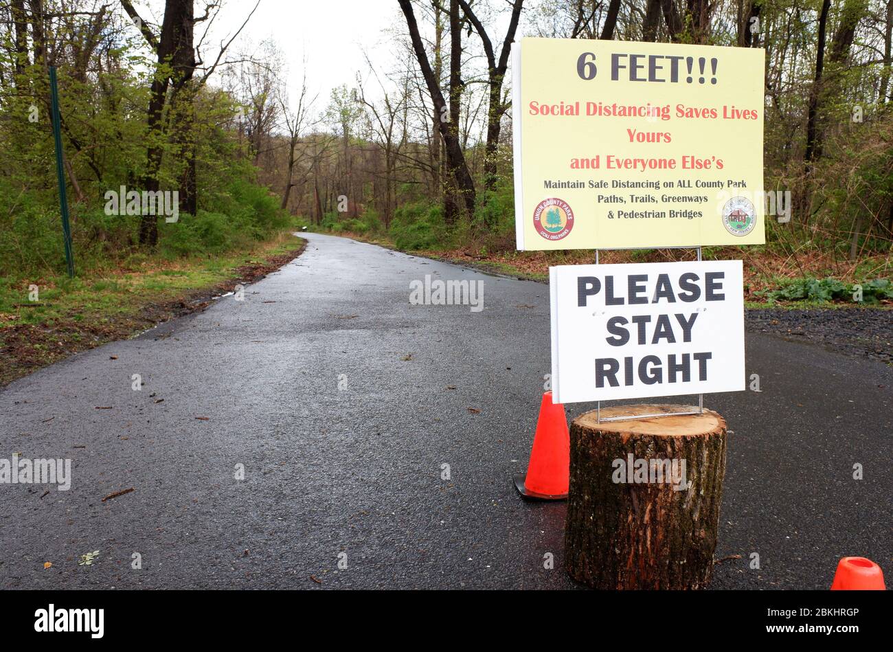 Warning sign of social distance at the entrance of the road to the deserted Village of Feltville during the lockdown of covid-19 coronavirus pandemic outbreak.Watchung Reservation, Berkeley Heights.New Jersey.USA Stock Photo