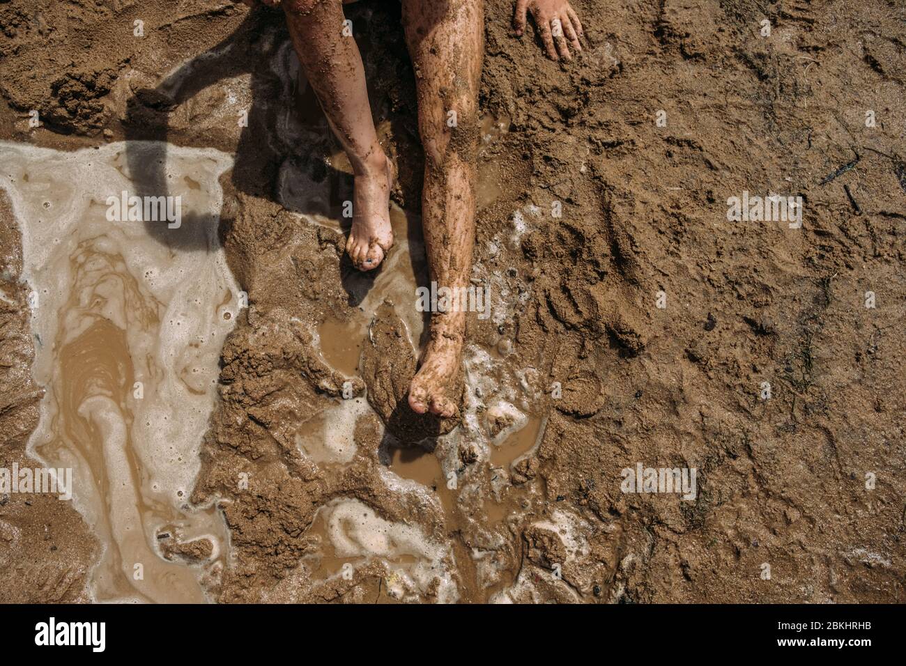 above shot of child's legs covered in mud Stock Photo Alamy