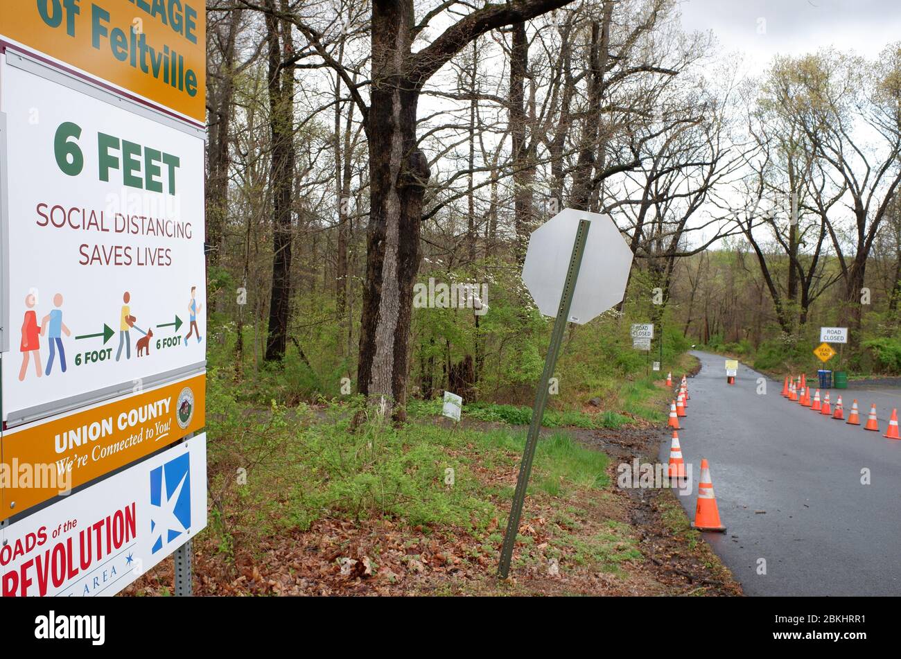 Park closed roadblock with warning sign of social distance by the entrance  of the deserted Village of Feltville during the lockdown of covid-19 coronavirus pandemic outbreak.Watchung Reservation, Berkeley Heights.New Jersey.USA Stock Photo