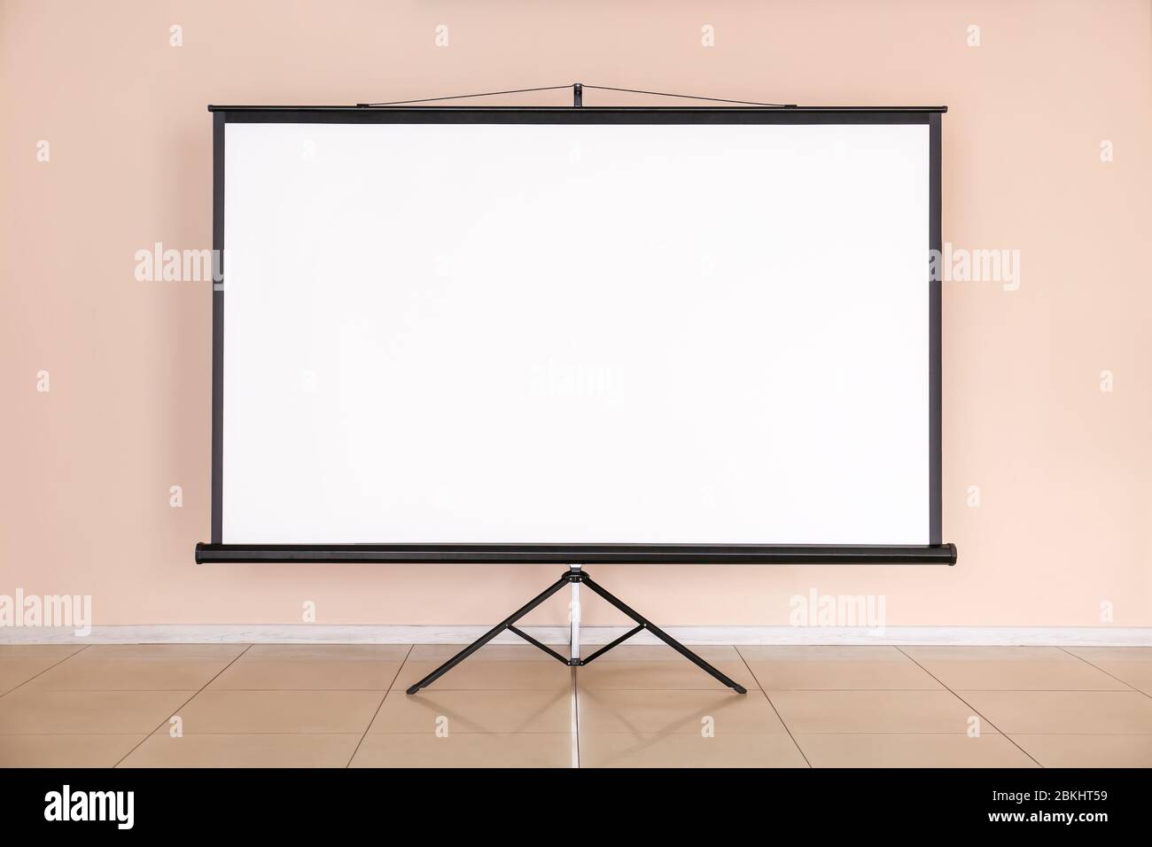 Modern projector screen near wall indoors Stock Photo Alamy