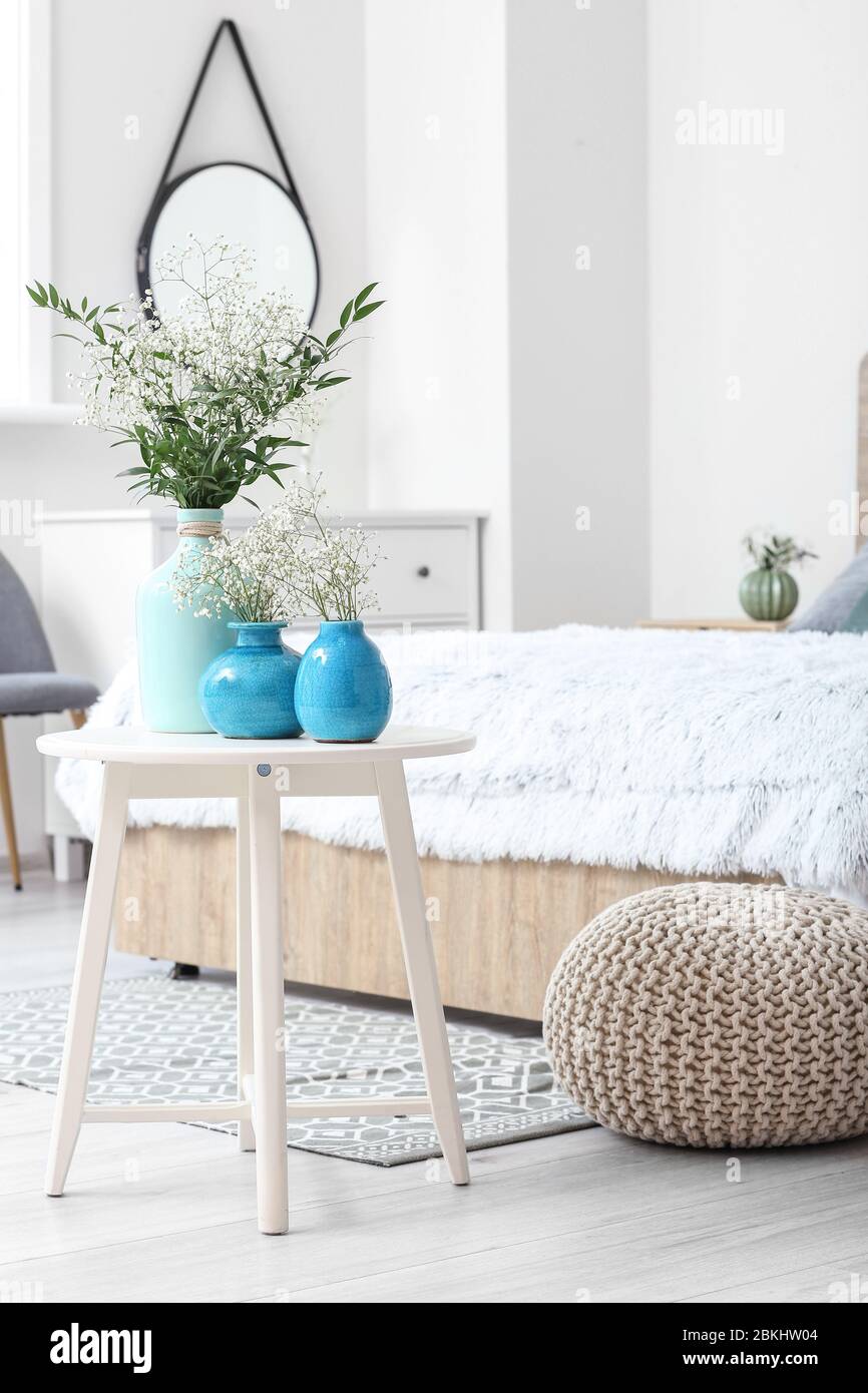 Vases with flowers in modern bedroom Stock Photo Alamy