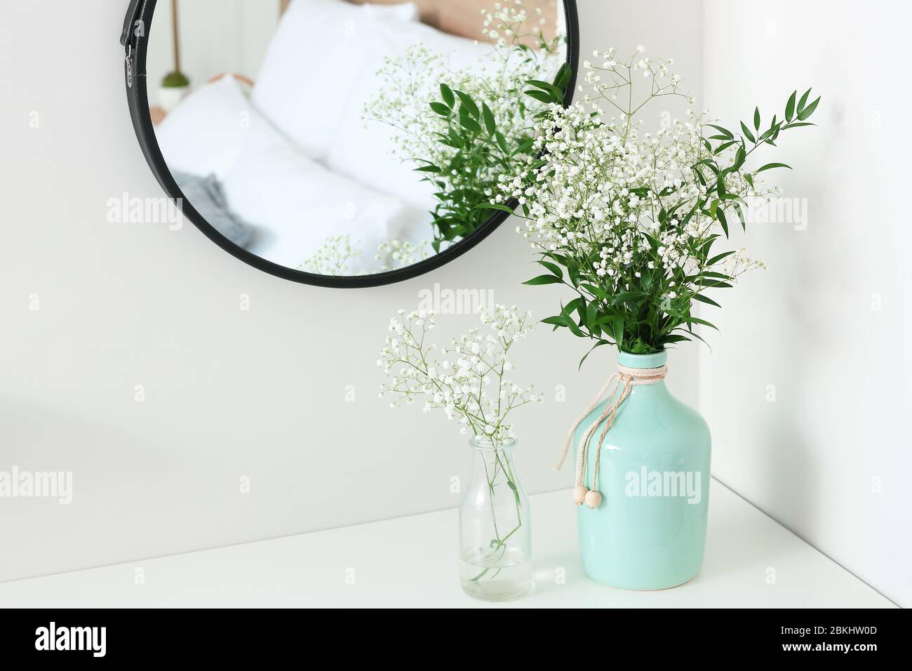 Vases with flowers in modern bedroom Stock Photo Alamy