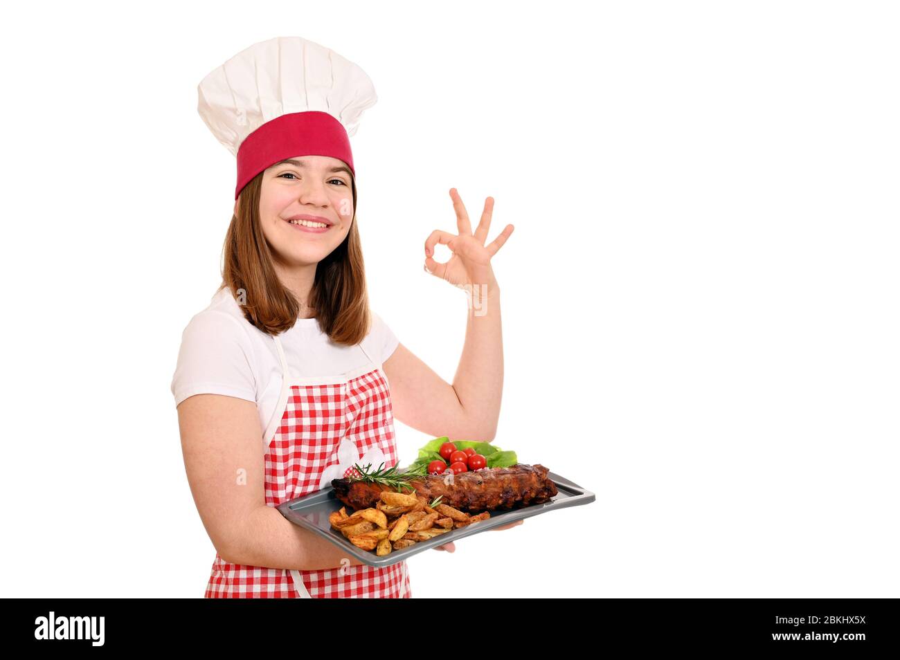 happy girl cook with pork spare ribs at plate and ok hand sign Stock Photo