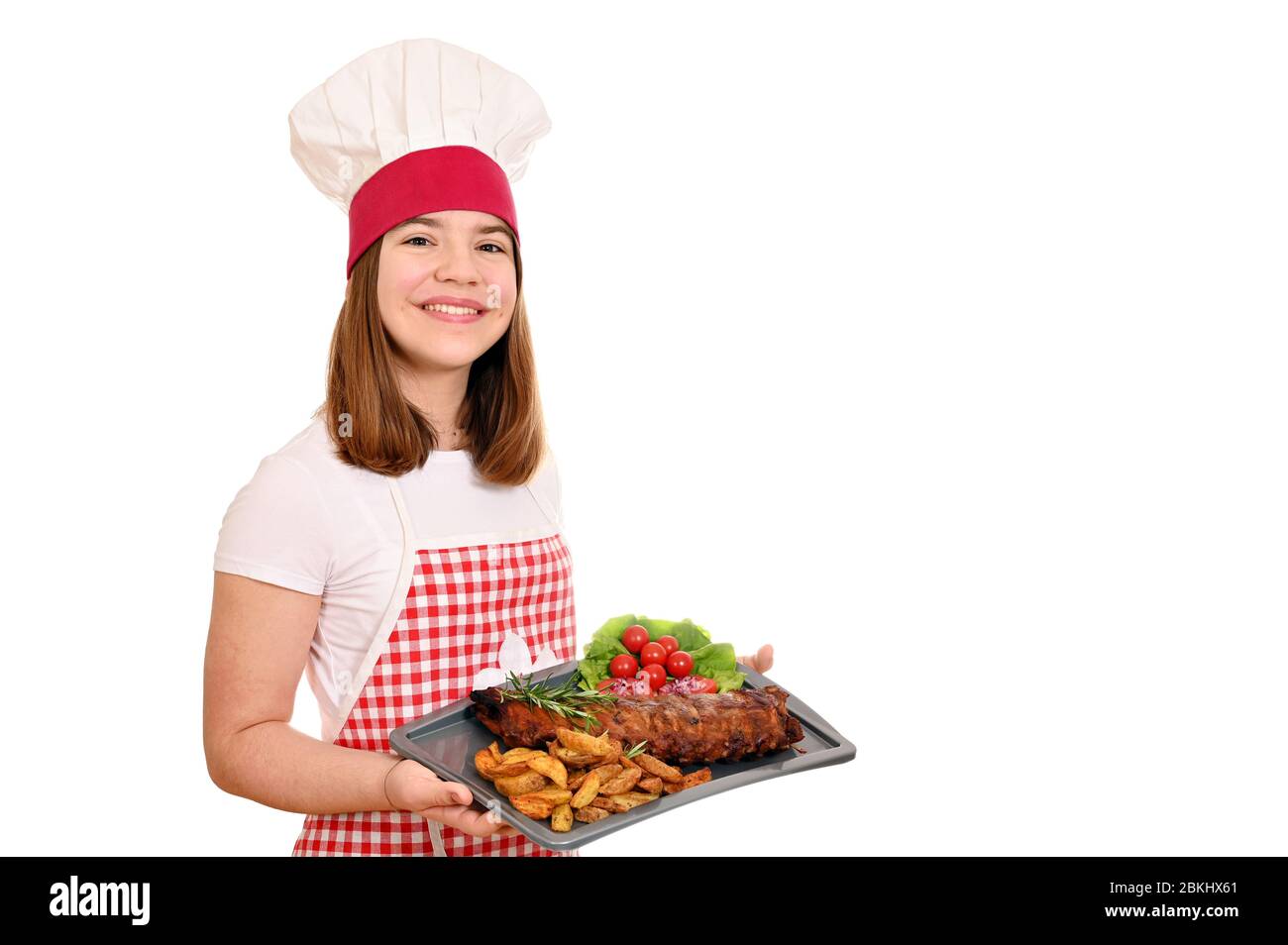happy girl cook with pork spare ribs at plate Stock Photo
