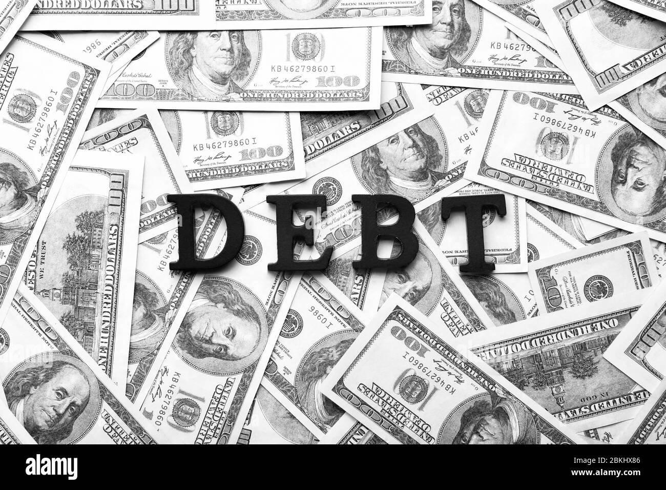 Word DEBT on dollar banknotes Stock Photo - Alamy