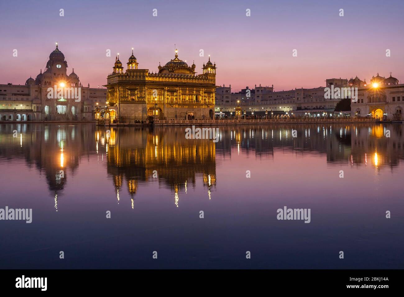 India, Punjab State, Amritsar, Harmandir Sahib, Golden Temple iluminated at dusk, with reflection in the Nectar Basin, Amrit Sarovar, holy place of Sikhism Stock Photo
