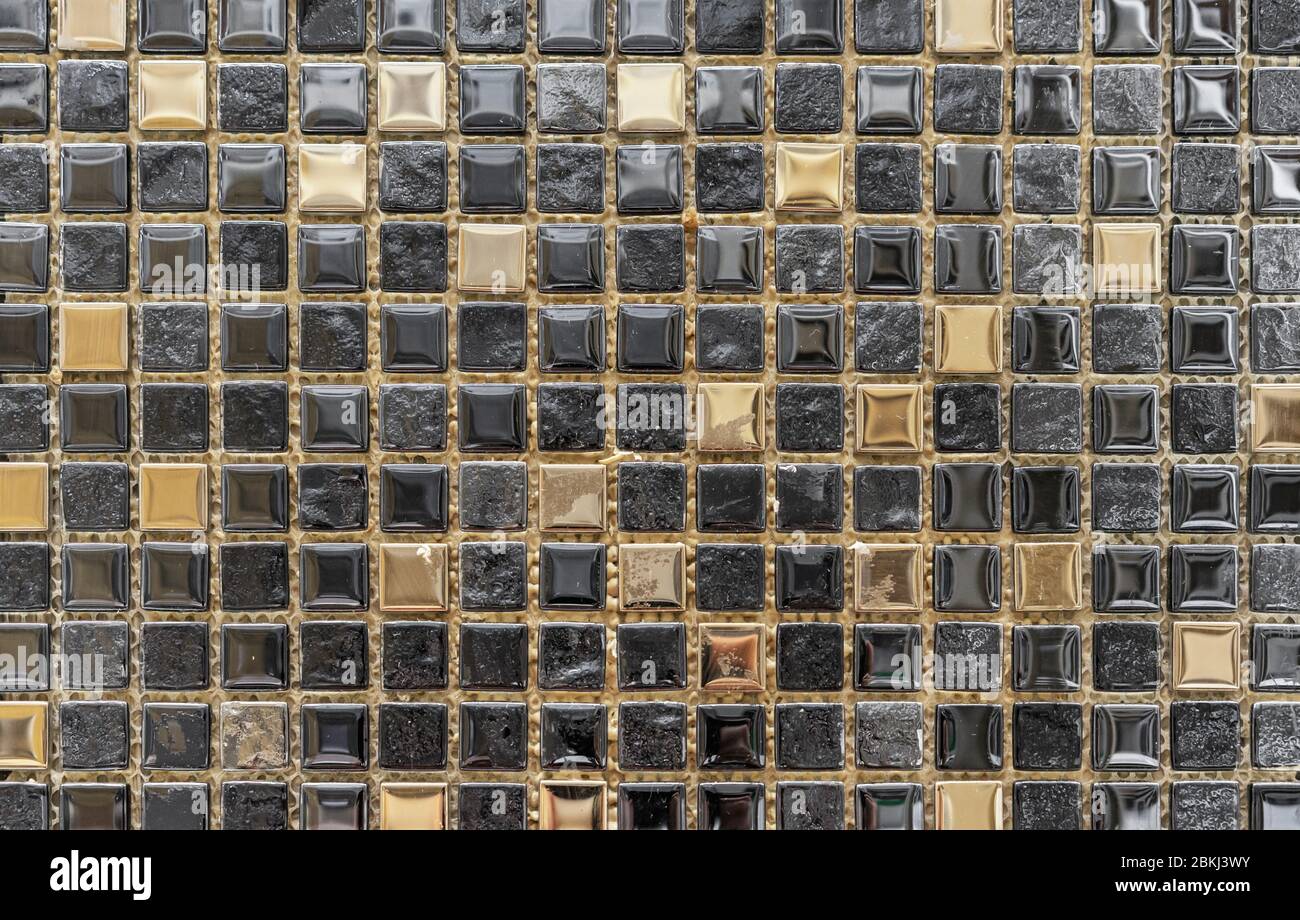 Black ceramic mosaic with gold accents for the design of the kitchen