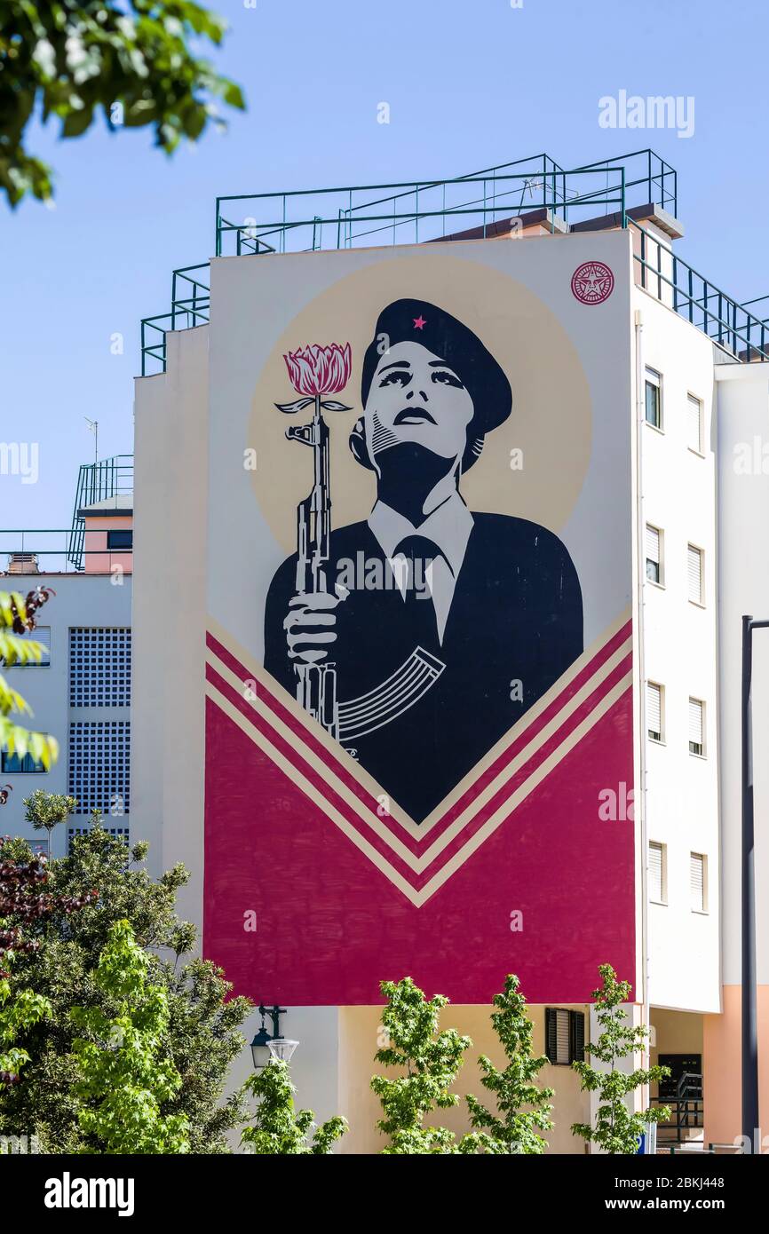 Portugal, Lisbon, Graça, Street art as memorial to the Carnation Revolution, female soldier with a gun with a carnation flower Stock Photo