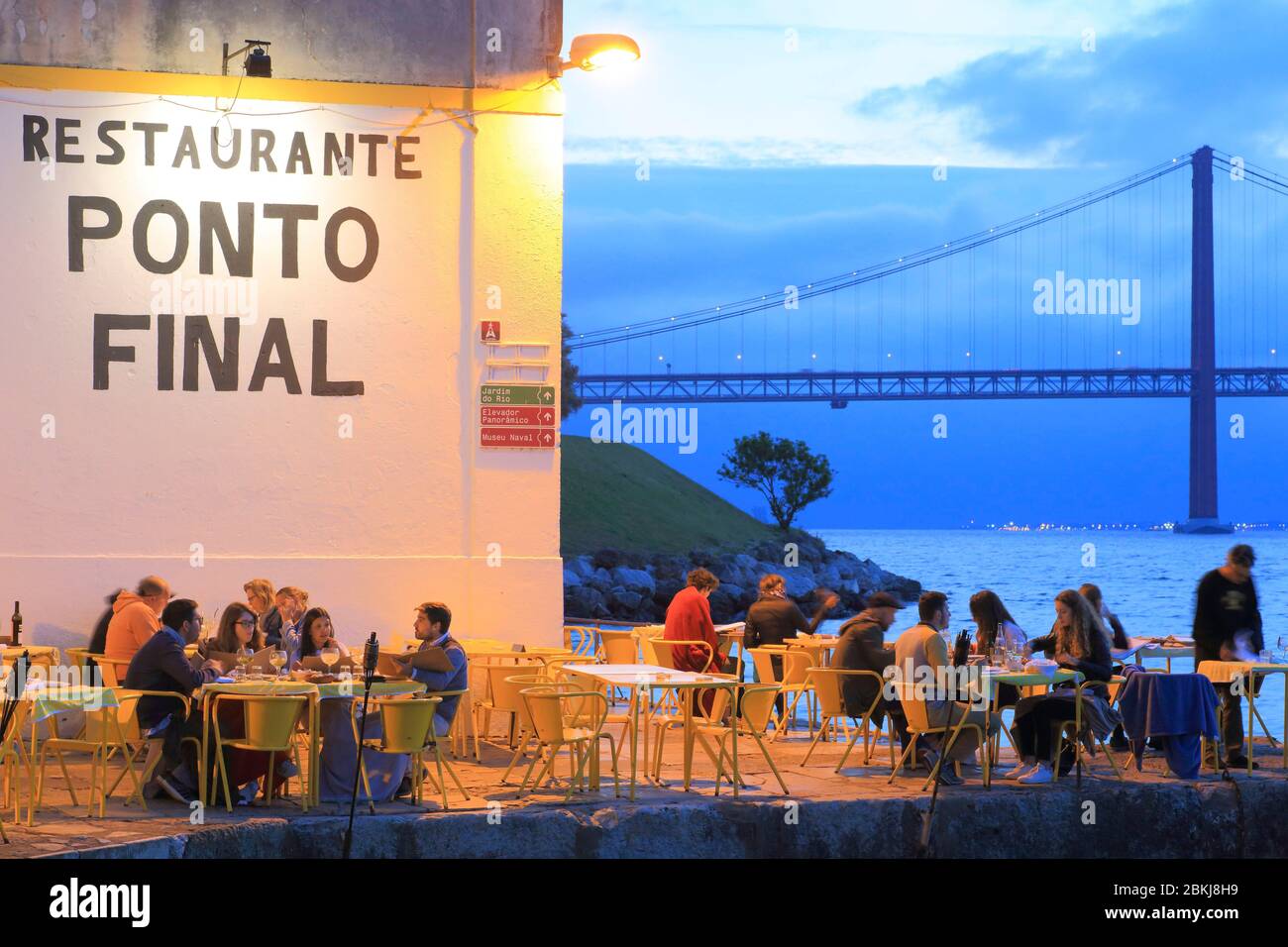 Portugal, Lisbon, Almada, traditional Portuguese restaurant Ponto Final on the Tagus river with Ponte 25 de Abril in the background Stock Photo