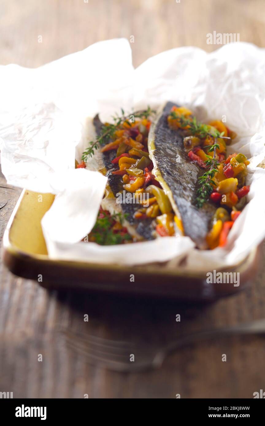 Sea bream fillet with bell pepper and curry en papillote Stock Photo