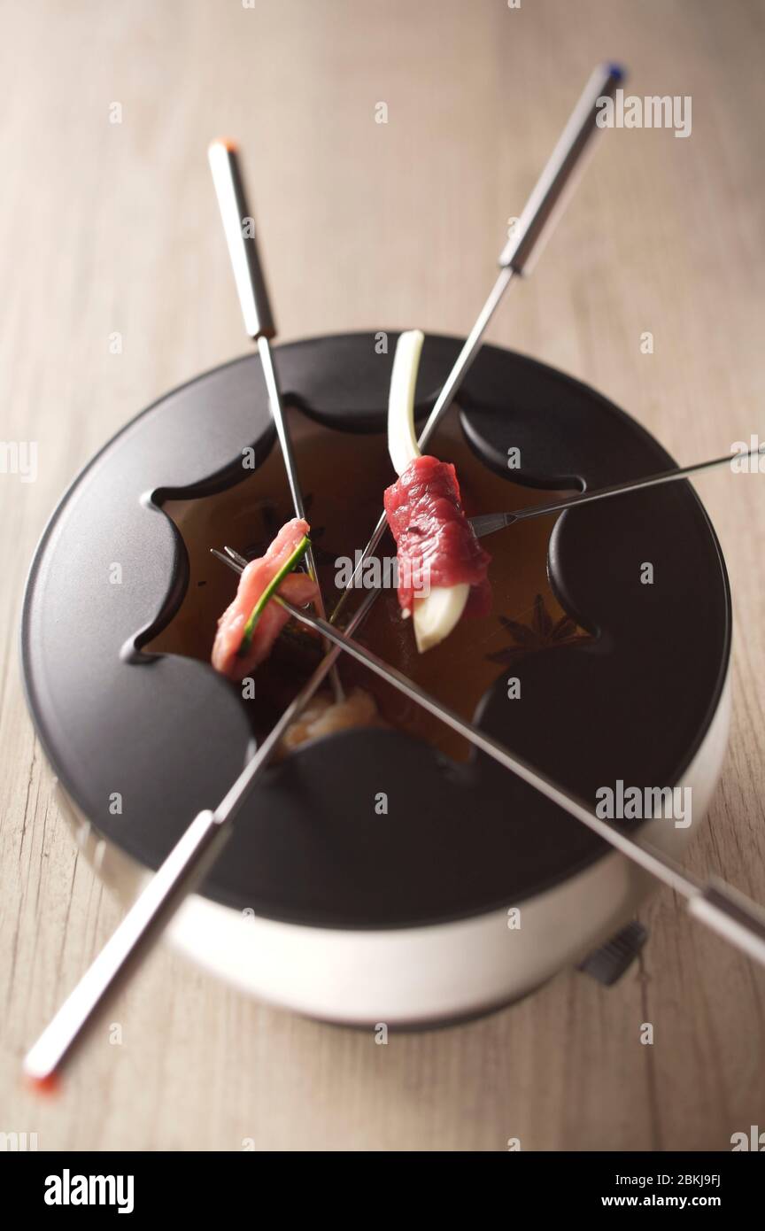 Meat fondue with broth Stock Photo Alamy