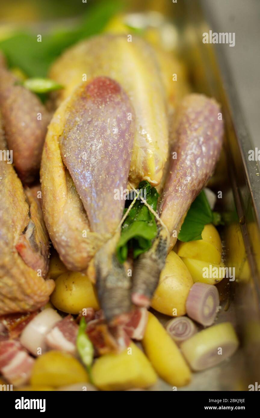 Guinea fowl with potatoes before Stock Photo